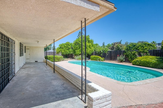 view of pool featuring a patio area and a fenced backyard