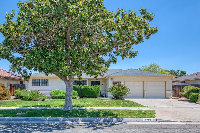 ranch-style home featuring a garage, driveway, and stucco siding