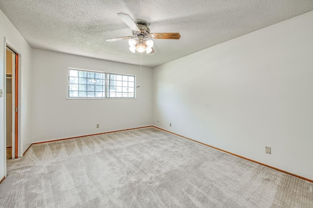 unfurnished bedroom with carpet floors, baseboards, a textured ceiling, and ceiling fan