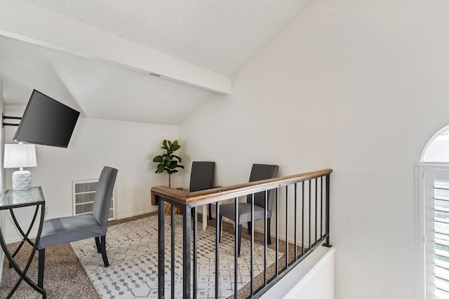 carpeted office featuring a textured ceiling