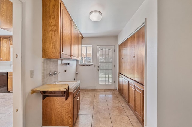laundry room with cabinet space, light tile patterned flooring, and hookup for a washing machine