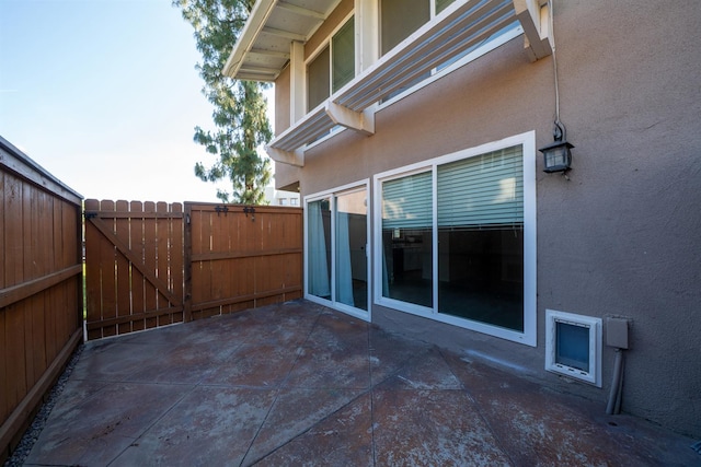 view of patio / terrace featuring fence and a gate