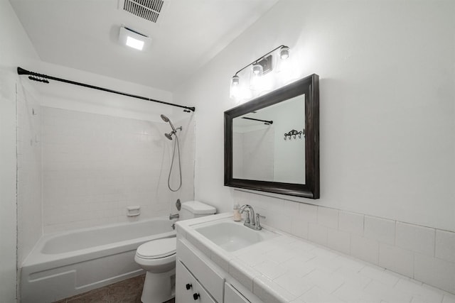 full bath featuring toilet, vanity, tub / shower combination, and tile patterned flooring