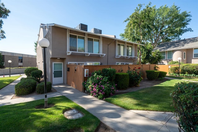 view of property featuring stucco siding and central AC unit