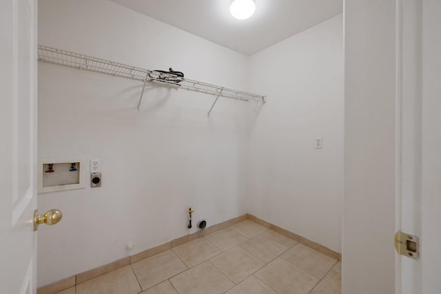 3225 N Mendonca St, Visalia, CA 93291 - washroom featuring gas dryer hookup, washer hookup, electric dryer hookup, light tile patterned floors, and baseboards