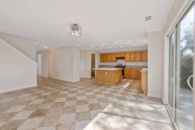 3225 N Mendonca St, Visalia, CA 93291 - kitchen with stainless steel gas range oven, light countertops, open floor plan, a kitchen island, and recessed lighting