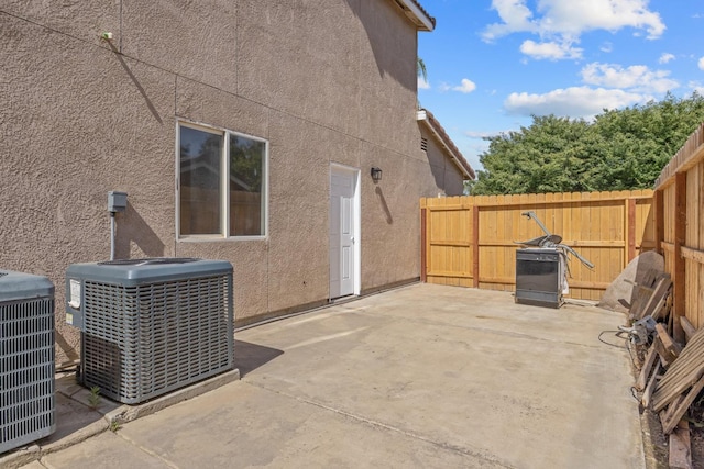 3225 N Mendonca St, Visalia, CA 93291 - view of property exterior with central AC, stucco siding, fence, and a patio area