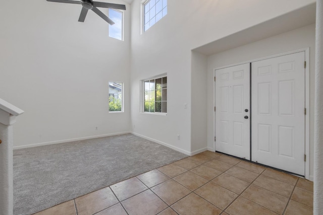 3225 N Mendonca St, Visalia, CA 93291 - foyer with light colored carpet, ceiling fan, healthy amount of natural light, light tile patterned floors, and a towering ceiling