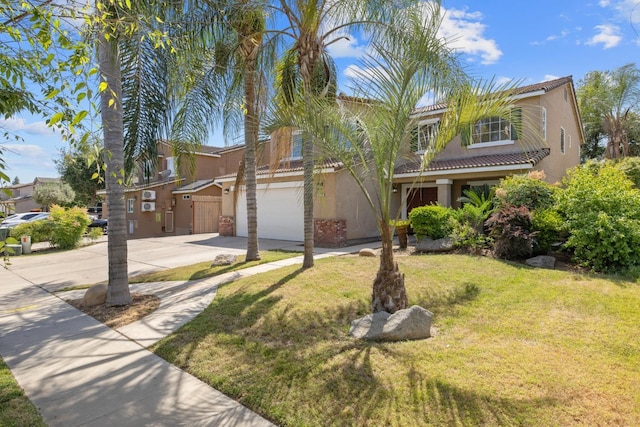 3225 N Mendonca St, Visalia, CA 93291 - view of front of home with stucco siding, driveway, an attached garage, a front lawn, and a tile roof