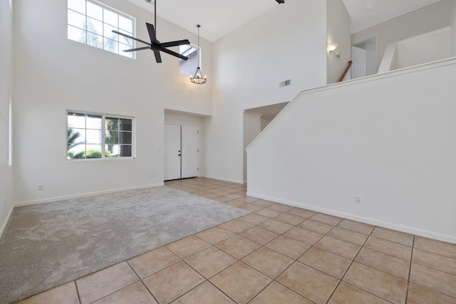 3225 N Mendonca St, Visalia, CA 93291 - carpeted foyer featuring plenty of natural light, ceiling fan, stairs, tile patterned flooring, and a high ceiling