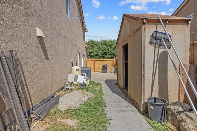 3225 N Mendonca St, Visalia, CA 93291 - view of side of property featuring fence, central air condition unit, and an outdoor structure
