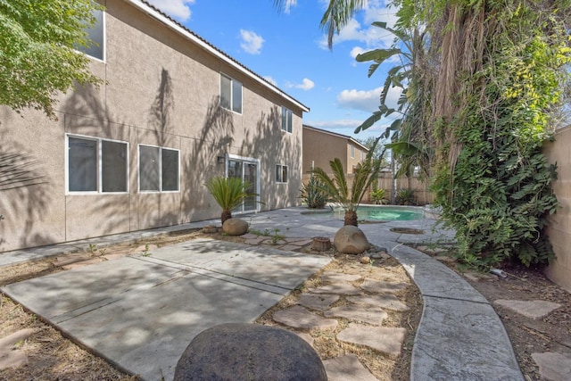 3225 N Mendonca St, Visalia, CA 93291 - rear view of house featuring stucco siding, a fenced backyard, and a patio