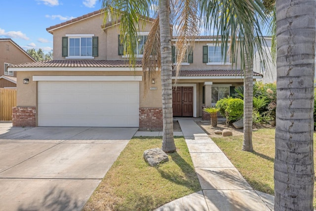3225 N Mendonca St, Visalia, CA 93291 - traditional-style house featuring stucco siding, brick siding, concrete driveway, and an attached garage
