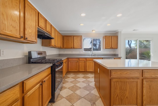 3225 N Mendonca St, Visalia, CA 93291 - kitchen with stainless steel gas stove, under cabinet range hood, crown molding, a sink, and light countertops