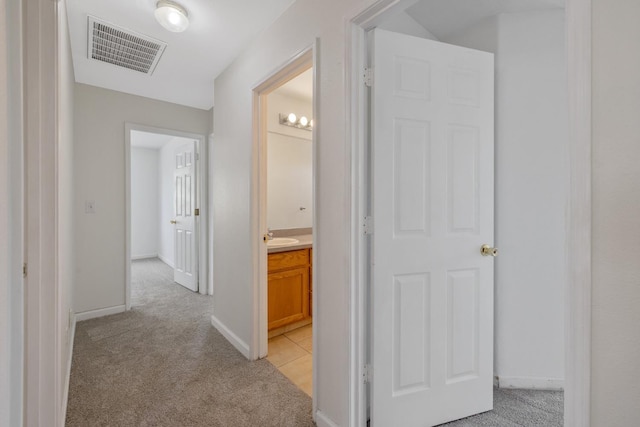 3225 N Mendonca St, Visalia, CA 93291 - corridor featuring light colored carpet, baseboards, and a sink