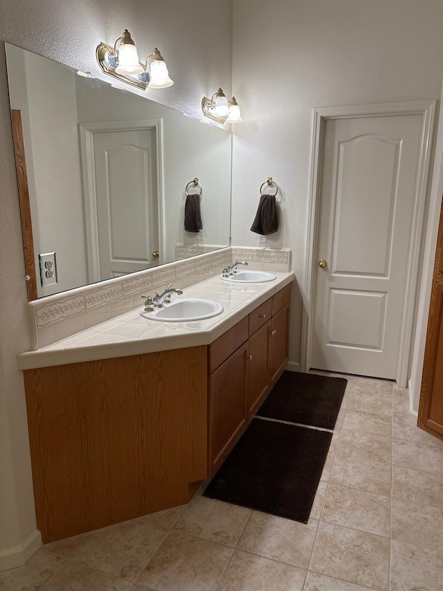 2644 Gibson Ave, Clovis, CA 93611 - bathroom with double vanity and tile patterned floors