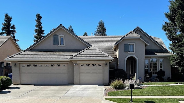 2644 Gibson Ave, Clovis, CA 93611 - traditional home featuring stucco siding, concrete driveway, an attached garage, and a front yard