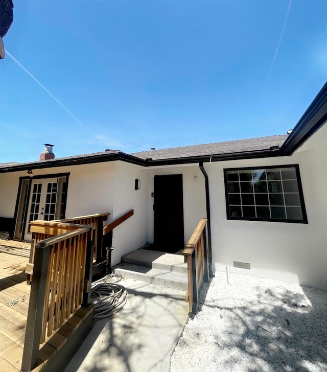 752 E Stuart Ave, Fresno, CA 93710 - property entrance with french doors, stucco siding, crawl space, and a chimney