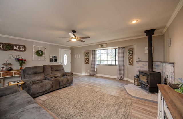 47438 Cheyenne Rd, Coarsegold, CA 93614 - living room with a wood stove, light wood-type flooring, a ceiling fan, ornamental molding, and baseboards