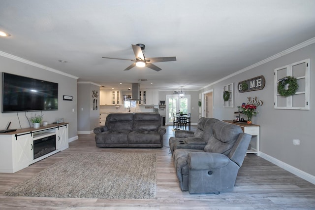 47438 Cheyenne Rd, Coarsegold, CA 93614 - living area featuring ceiling fan, light wood finished floors, baseboards, crown molding, and a chandelier