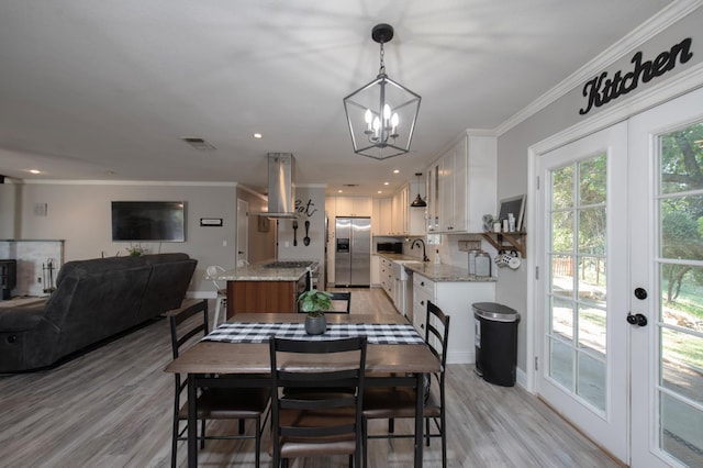 47438 Cheyenne Rd, Coarsegold, CA 93614 - dining room featuring french doors, ornamental molding, a chandelier, light wood finished floors, and baseboards