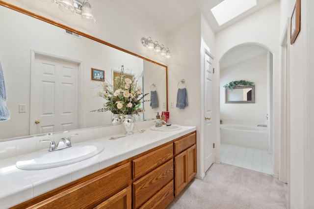5532 N Cleo Ave, Fresno, CA 93722 - full bath with a skylight, double vanity, and a tub