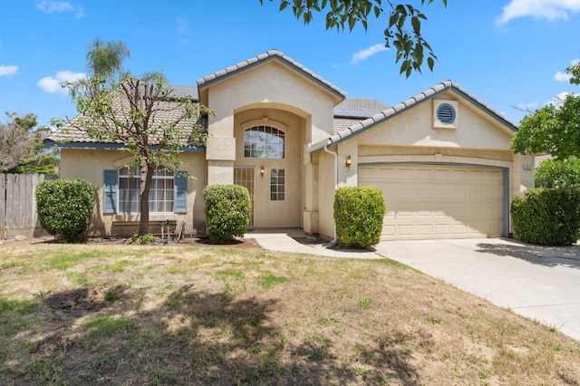5532 N Cleo Ave, Fresno, CA 93722 - mediterranean / spanish-style house with stucco siding, an attached garage, driveway, solar panels, and a tile roof