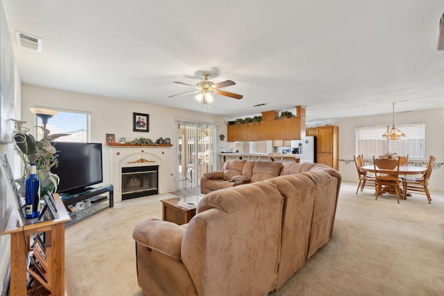 5532 N Cleo Ave, Fresno, CA 93722 - living room featuring light colored carpet, plenty of natural light, and a fireplace with flush hearth