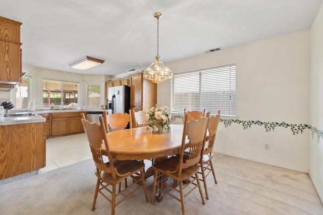 5532 N Cleo Ave, Fresno, CA 93722 - dining area featuring a chandelier and light colored carpet