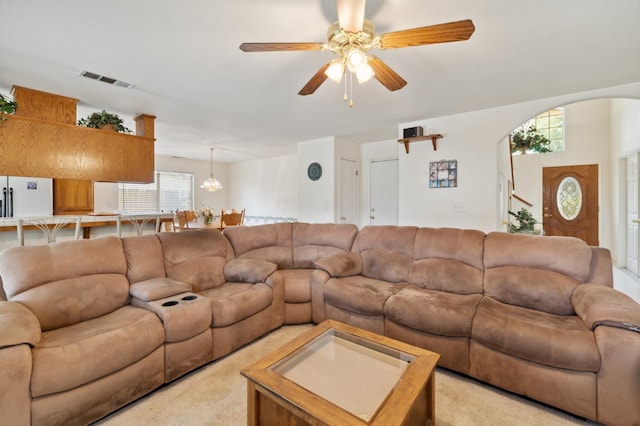 5532 N Cleo Ave, Fresno, CA 93722 - living room with a ceiling fan, light colored carpet, arched walkways, and a chandelier