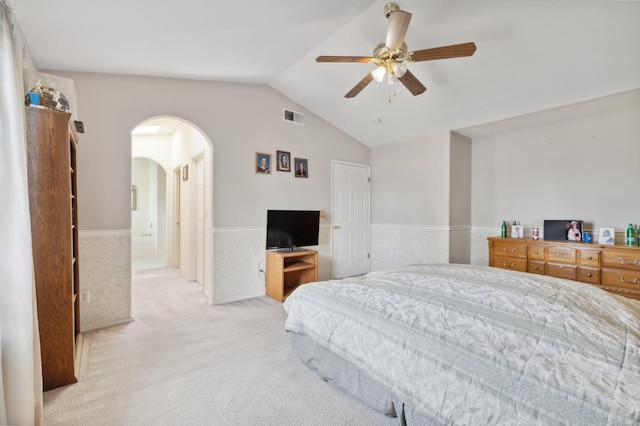 5532 N Cleo Ave, Fresno, CA 93722 - carpeted bedroom featuring a wainscoted wall, arched walkways, lofted ceiling, and a ceiling fan