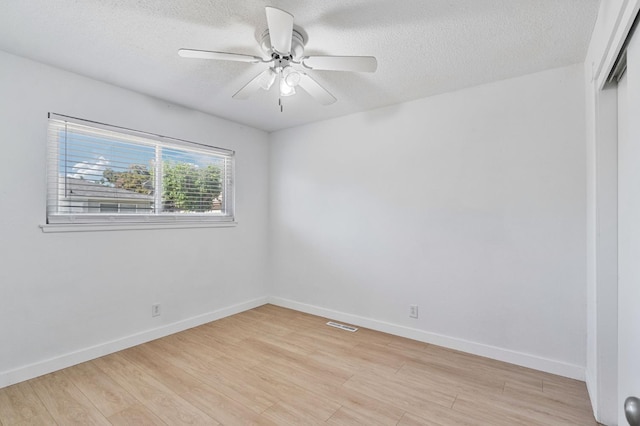 638 W Dennis Dr, Clovis, CA 93612 - spare room featuring light wood-style floors, a textured ceiling, ceiling fan, and baseboards