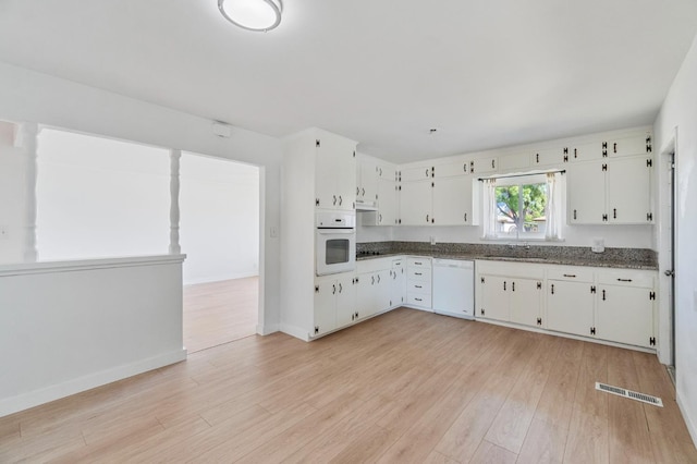 638 W Dennis Dr, Clovis, CA 93612 - kitchen with white appliances, light wood finished floors, white cabinets, and baseboards