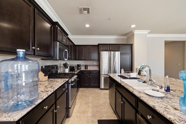 3874 Hampton Way, Clovis, CA 93619 - kitchen featuring appliances with stainless steel finishes, a sink, crown molding, light stone counters, and dark brown cabinets