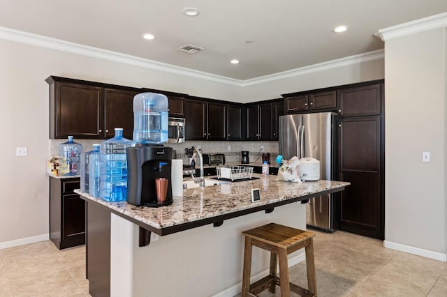 3874 Hampton Way, Clovis, CA 93619 - kitchen with stainless steel appliances, a kitchen bar, tasteful backsplash, light stone counters, and a center island with sink