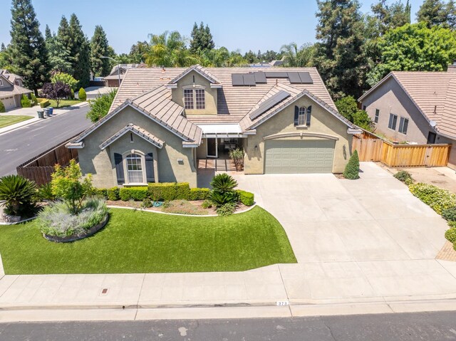 373 W Houston Ave, Clovis, CA 93611 - view of front of house with stucco siding, solar panels, concrete driveway, and a tiled roof