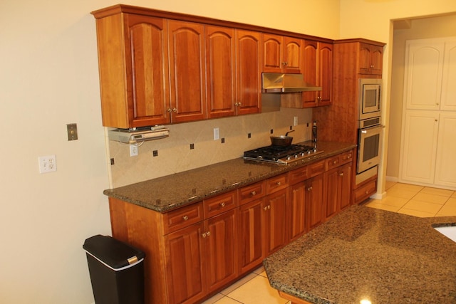 373 W Houston Ave, Clovis, CA 93611 - kitchen featuring appliances with stainless steel finishes, under cabinet range hood, backsplash, and dark stone countertops