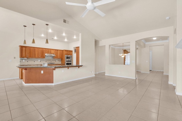 373 W Houston Ave, Clovis, CA 93611 - kitchen featuring high vaulted ceiling, appliances with stainless steel finishes, light tile patterned flooring, ceiling fan, and arched walkways