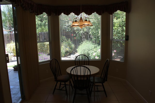 373 W Houston Ave, Clovis, CA 93611 - tiled dining room with baseboards, plenty of natural light, and a chandelier