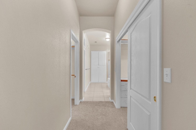 373 W Houston Ave, Clovis, CA 93611 - hall featuring arched walkways, light carpet, and a textured wall