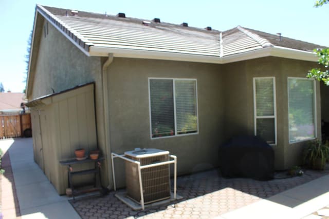 373 W Houston Ave, Clovis, CA 93611 - rear view of house with a patio, stucco siding, central air condition unit, fence, and a tiled roof
