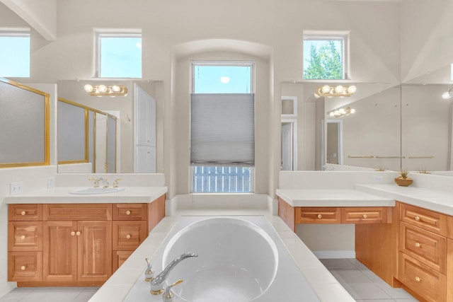 373 W Houston Ave, Clovis, CA 93611 - bathroom featuring a shower stall, two vanities, a garden tub, and tile patterned floors