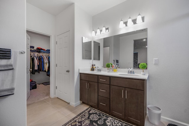 746 E Curtis Ave, Fowler, CA 93625 - full bath featuring double vanity, tile patterned flooring, baseboards, and a walk in closet