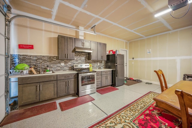 746 E Curtis Ave, Fowler, CA 93625 - kitchen with stainless steel electric range, freestanding refrigerator, under cabinet range hood, light countertops, and dark aggregate flooring