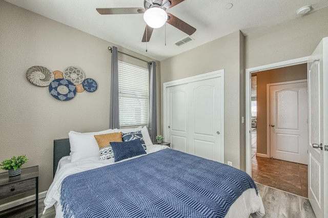 bedroom with a closet, ceiling fan, and wood finished floors