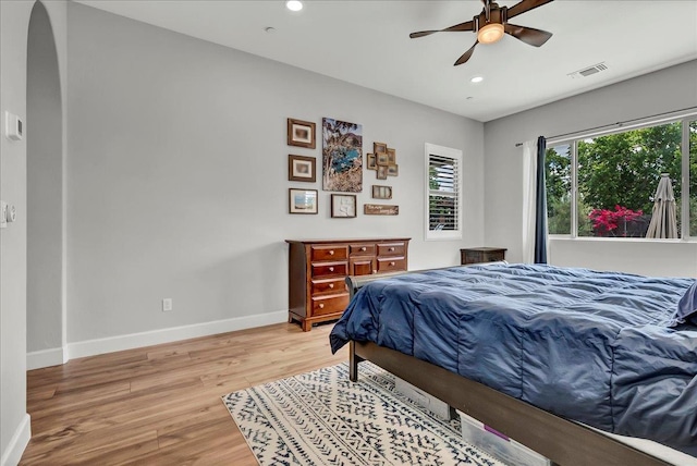 2315 W Malone St, Hanford, CA 93230 - bedroom with arched walkways, baseboards, light wood-style floors, recessed lighting, and a ceiling fan