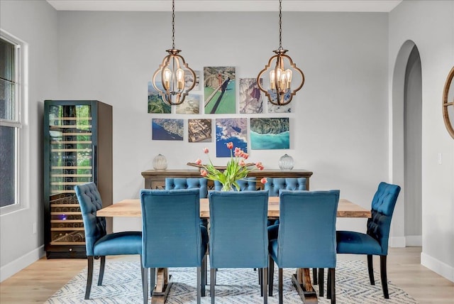 2315 W Malone St, Hanford, CA 93230 - dining space featuring a chandelier, beverage cooler, light wood finished floors, and baseboards