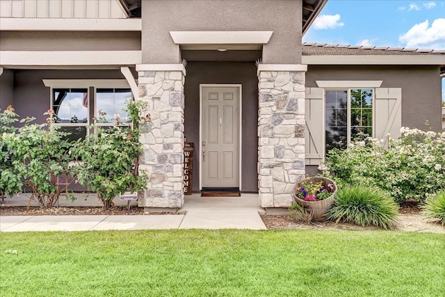 2315 W Malone St, Hanford, CA 93230 - property entrance with stucco siding, stone siding, and a yard