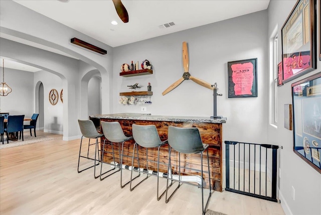 2315 W Malone St, Hanford, CA 93230 - indoor dry bar featuring arched walkways, light wood-type flooring, baseboards, and a ceiling fan
