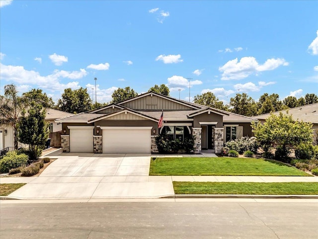 2315 W Malone St, Hanford, CA 93230 - view of front facade with stone siding, a garage, concrete driveway, and a front yard